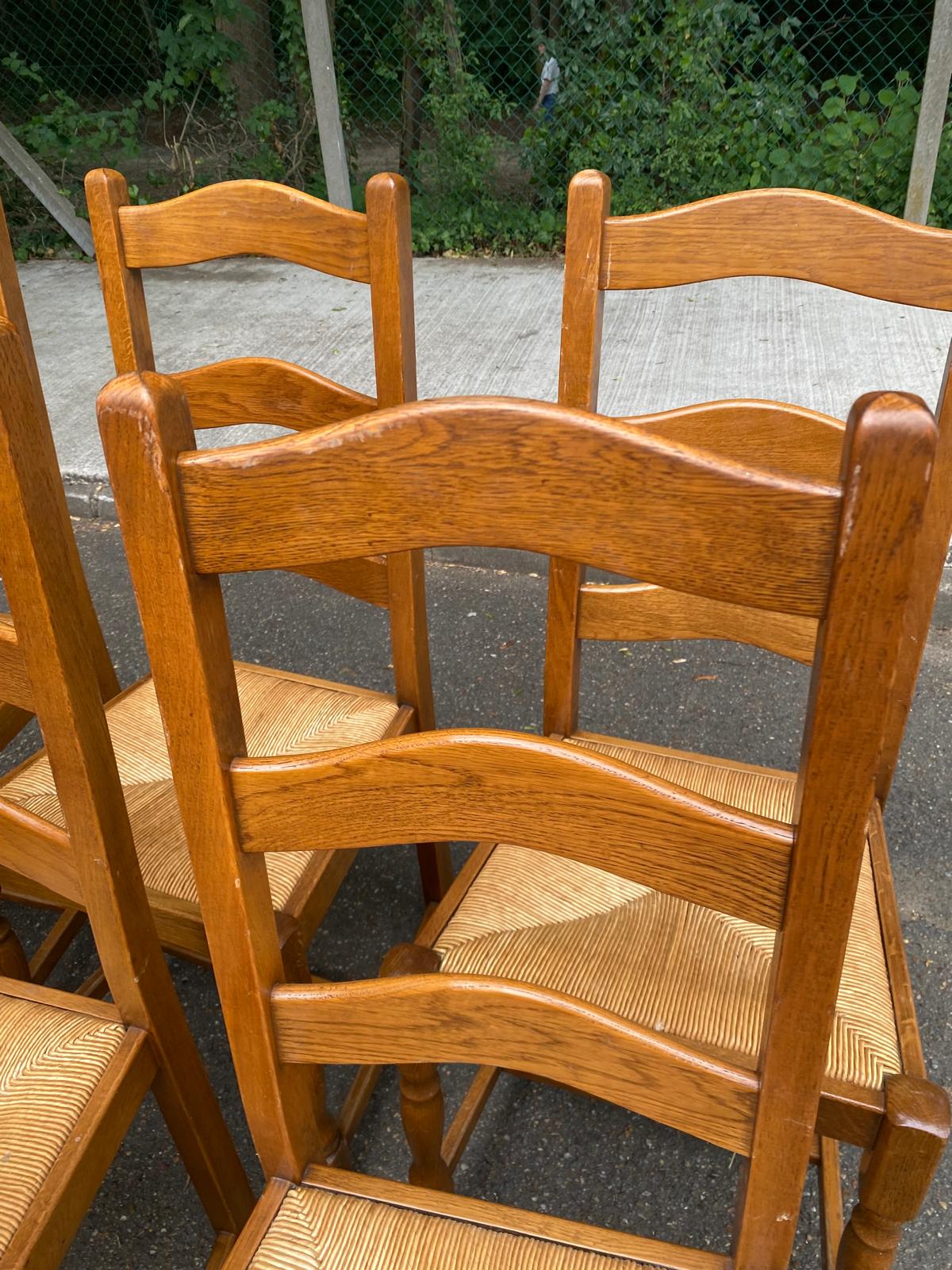 6 solid oak dining chairs with rush seats from the 1980s.