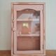 Medicine cabinet in patinated pink wood