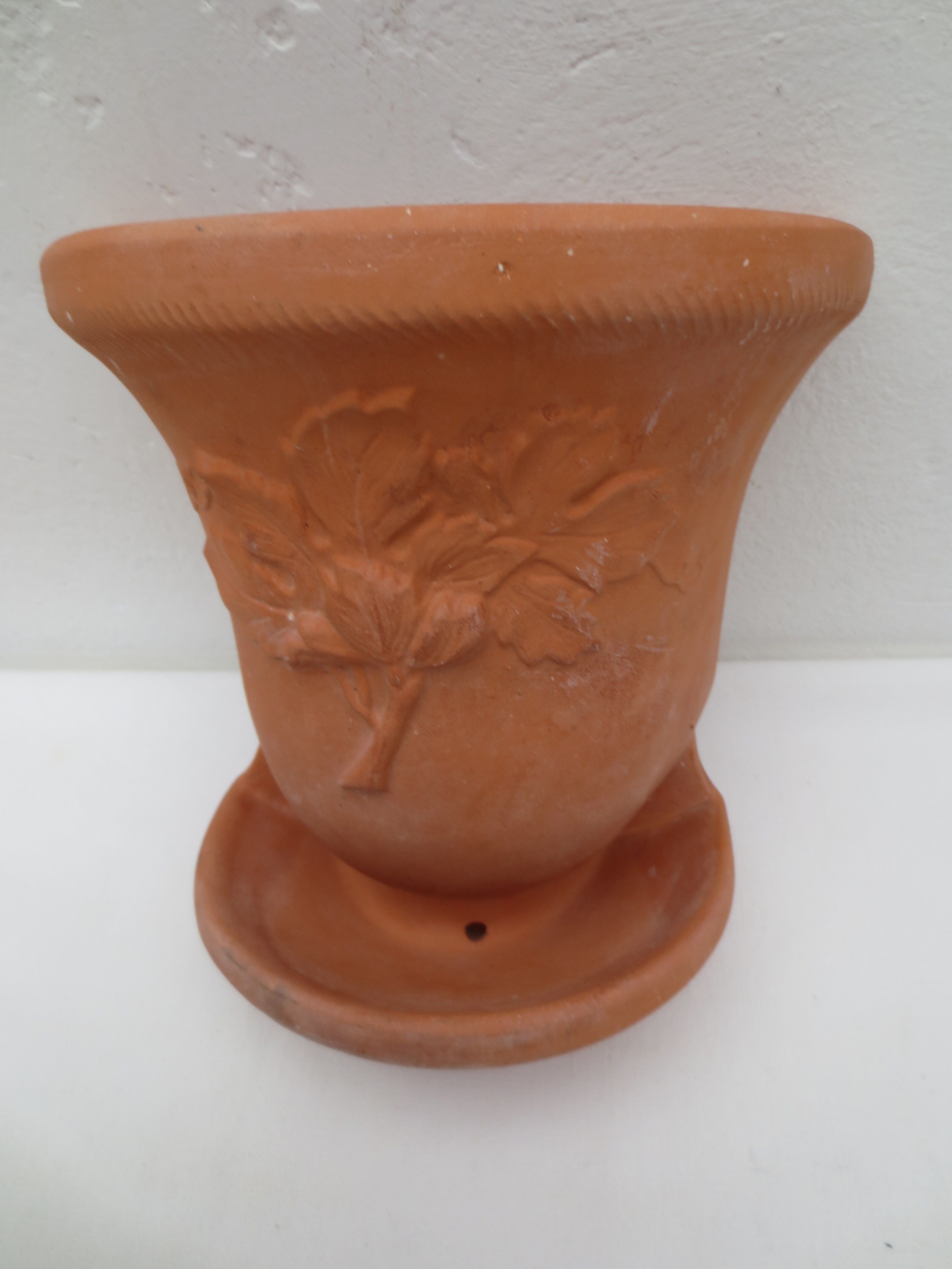Duo of decorated terracotta wall flowerpots