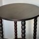 Set of side table and 2 stools, stained black wood, Circa 1950.