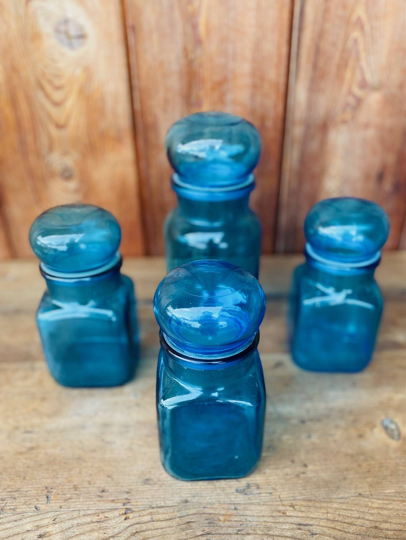 Set of 4 vintage blue glass jars.