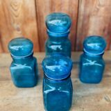 Set of 4 vintage blue glass jars.