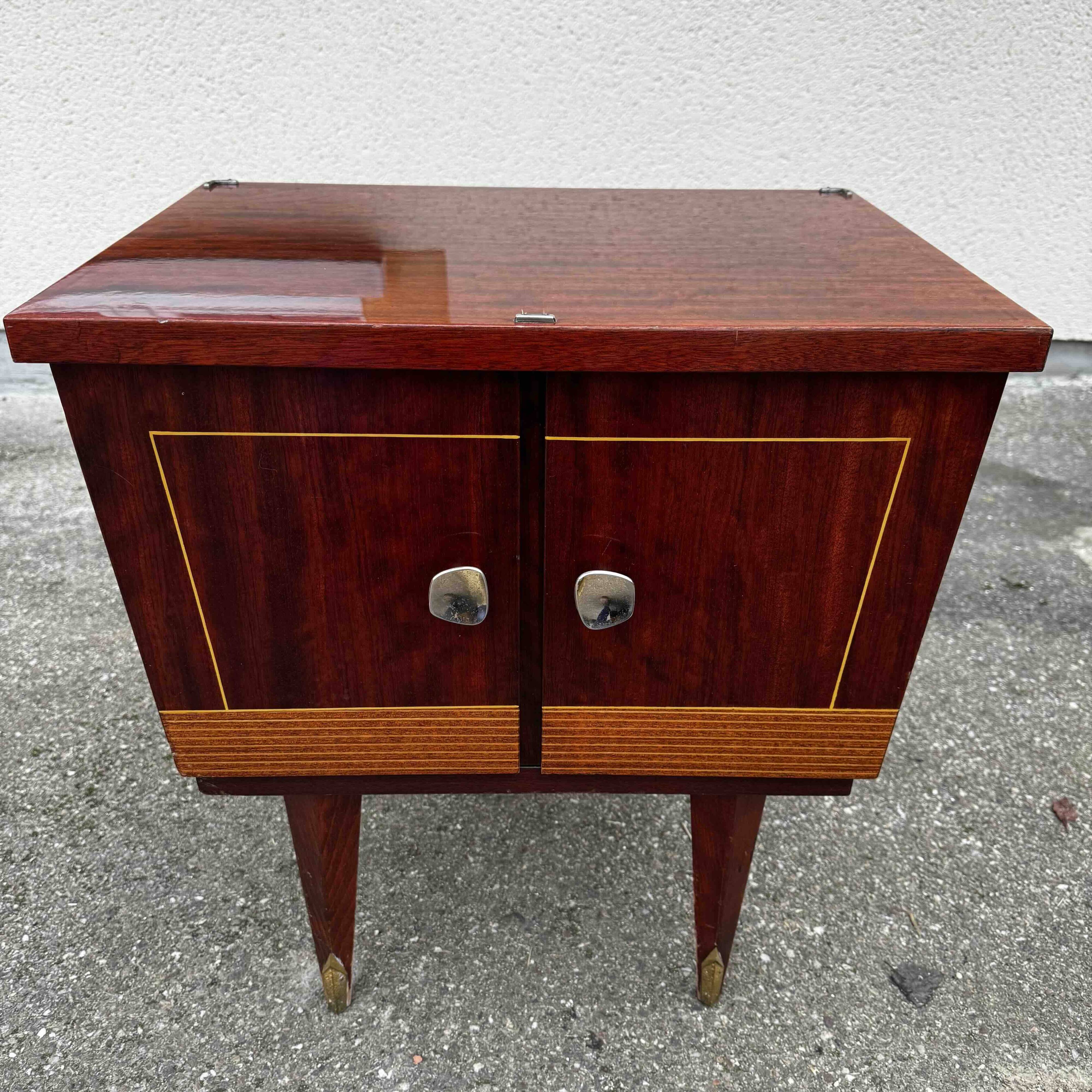 1950s bedside table in varnished wood veneer and brass.