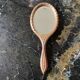 Hand-facing beveled mirror surrounded by wood dimension: height -38cm- width -15.5cm-