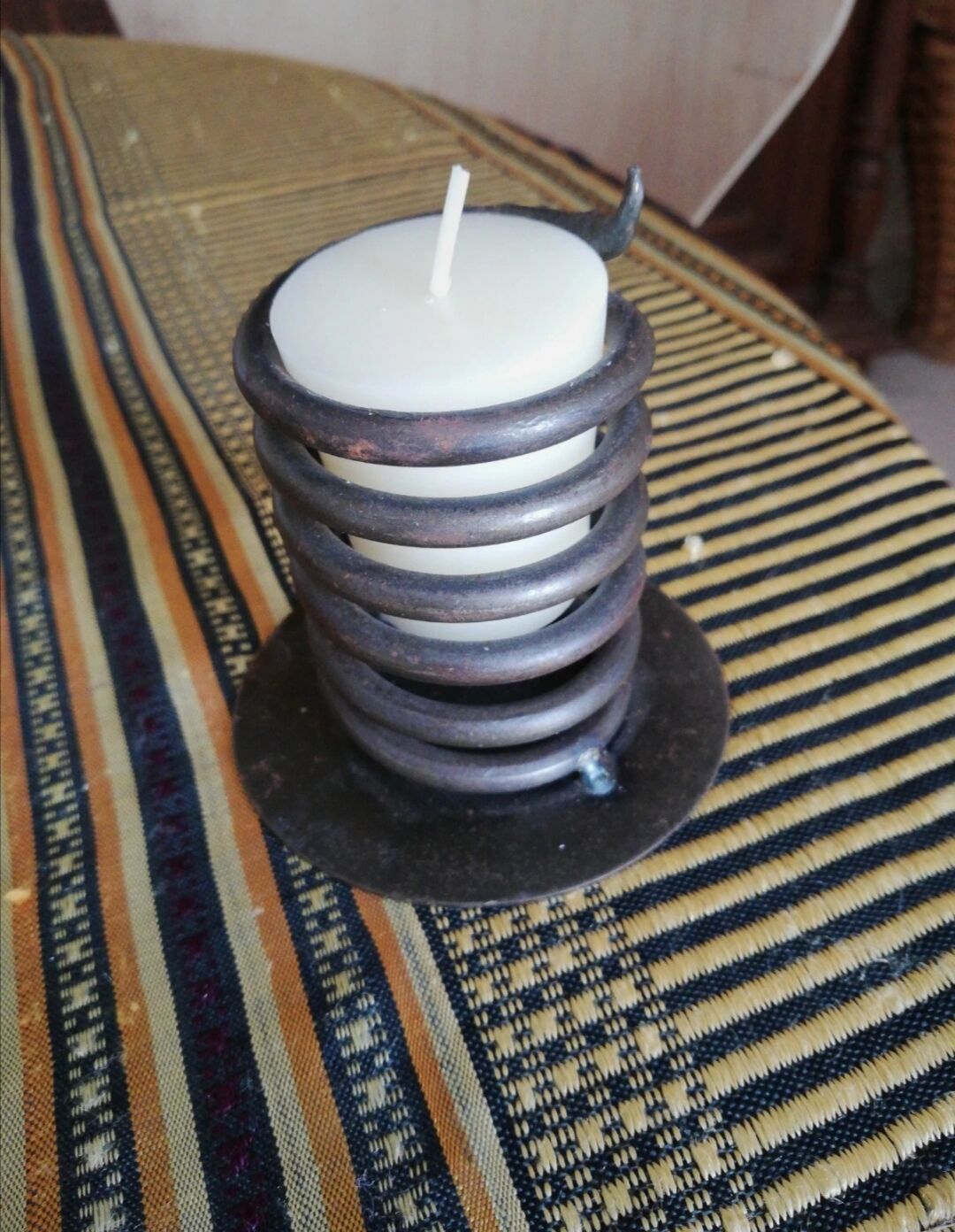 Spiral metal candle holder spring with candle, bronze appearance