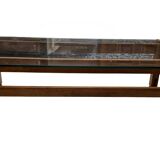 Glass coffee table with a wooden frame.