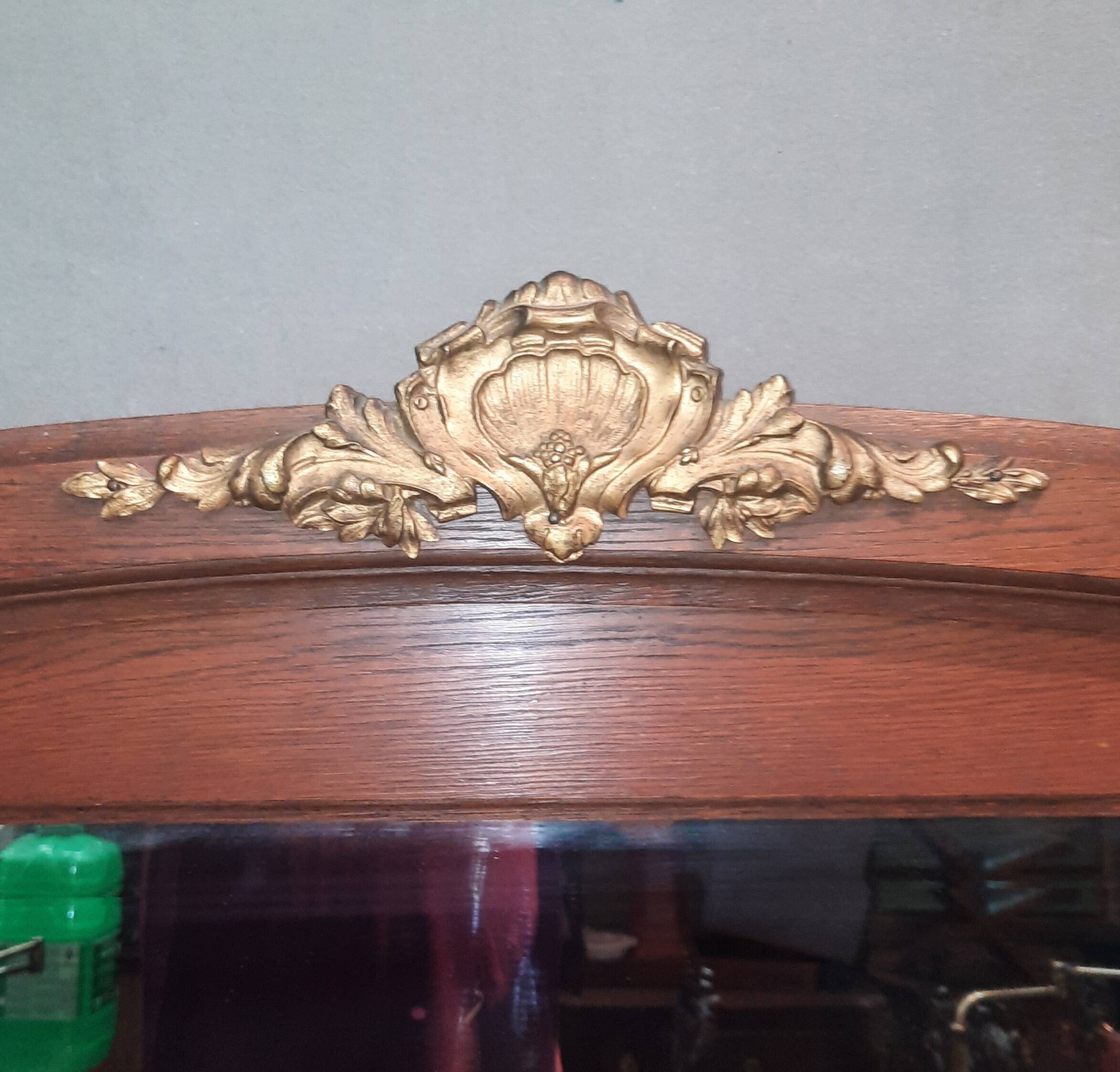 Bevelled mirror surrounded by a wooden frame.