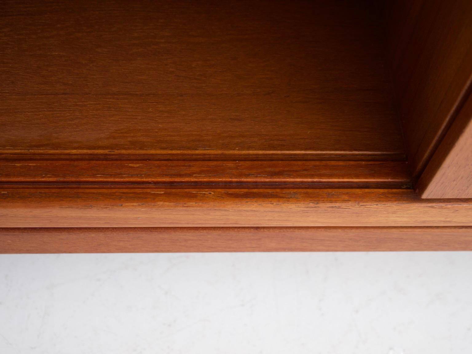 Modern mid-century teak sideboard with brass details.