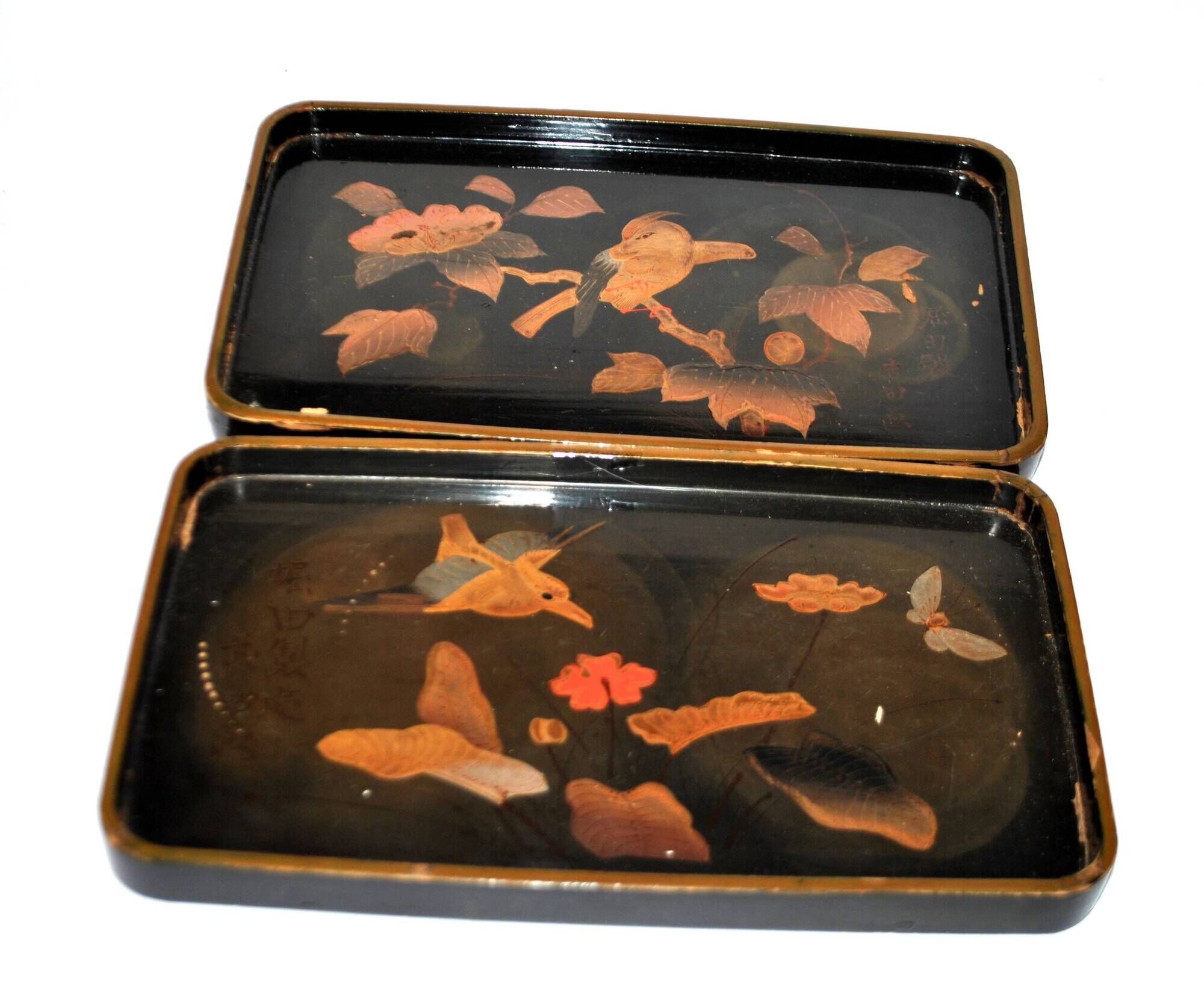 Set of two brown and black Chinese lacquer trays with bird decor