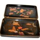 Set of two brown and black Chinese lacquer trays with bird decor