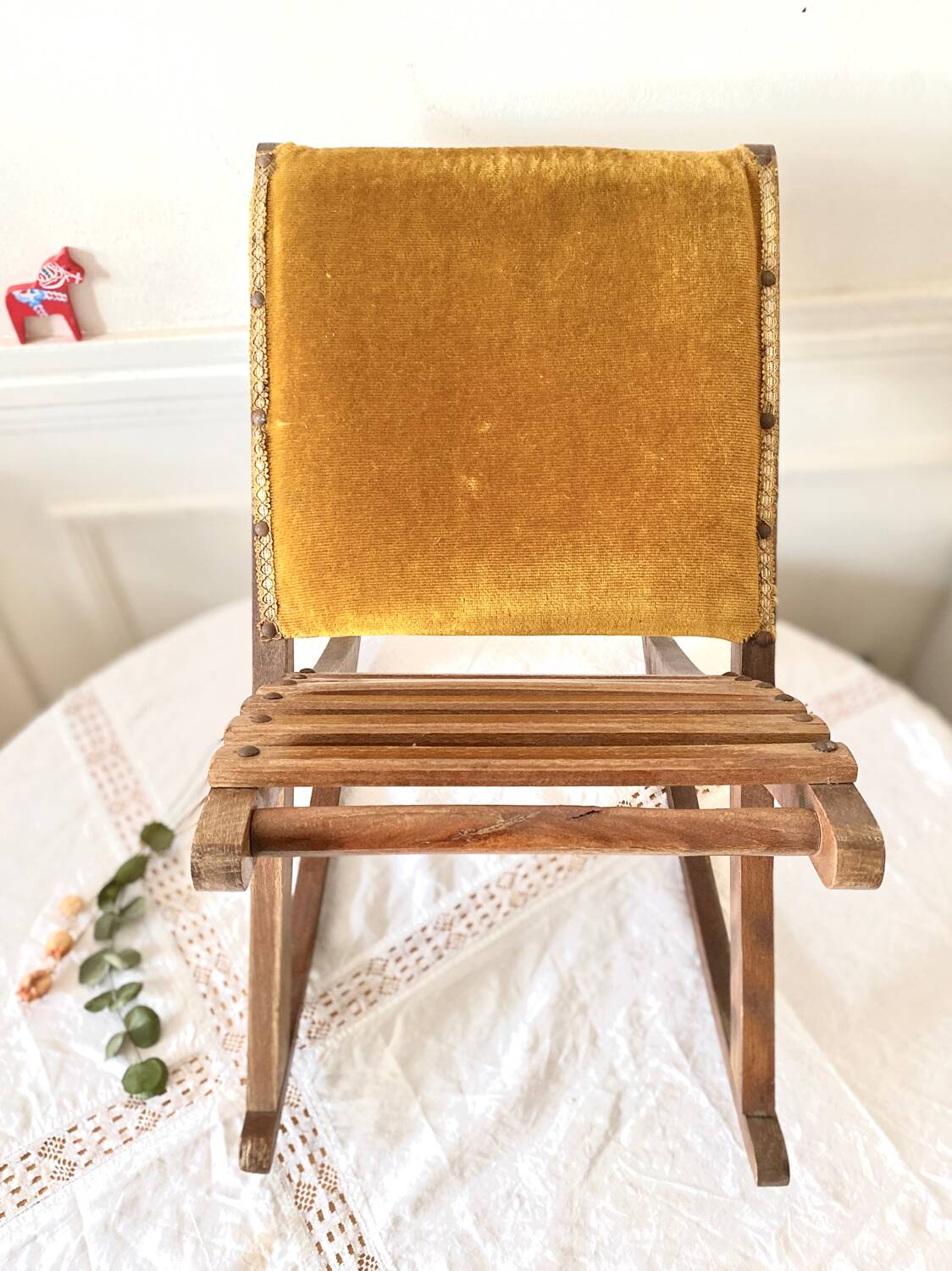 Old wooden rocking footrest with velvet fabric
