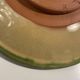 Decorative glazed terracotta plate with olive leaf pattern.