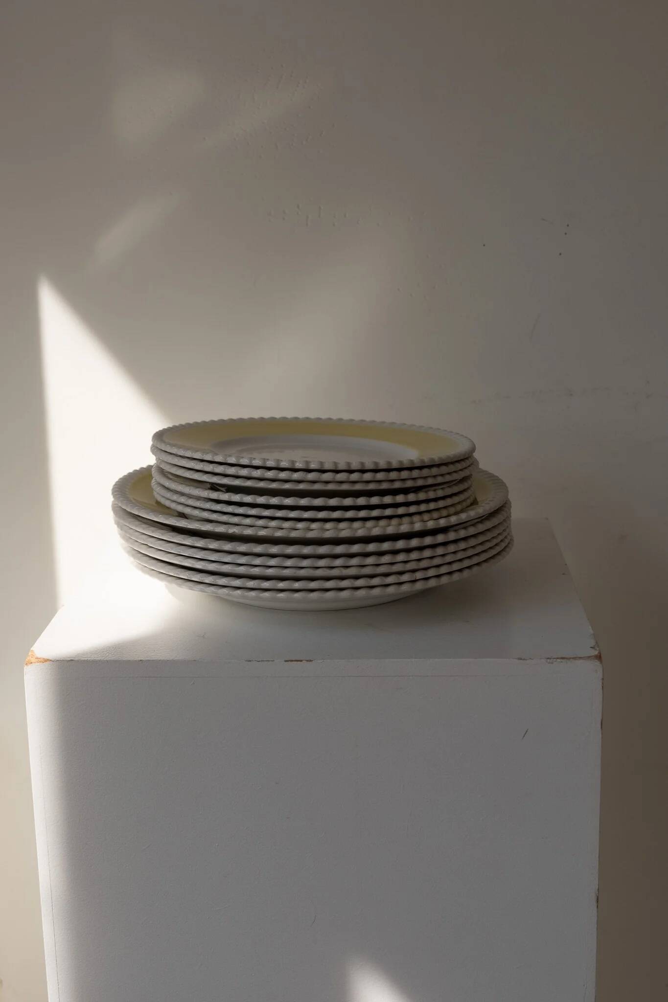 Vintage yellow butter ceramic dinnerware set with swirl border.