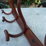 Coat rack with four double curved wooden pads