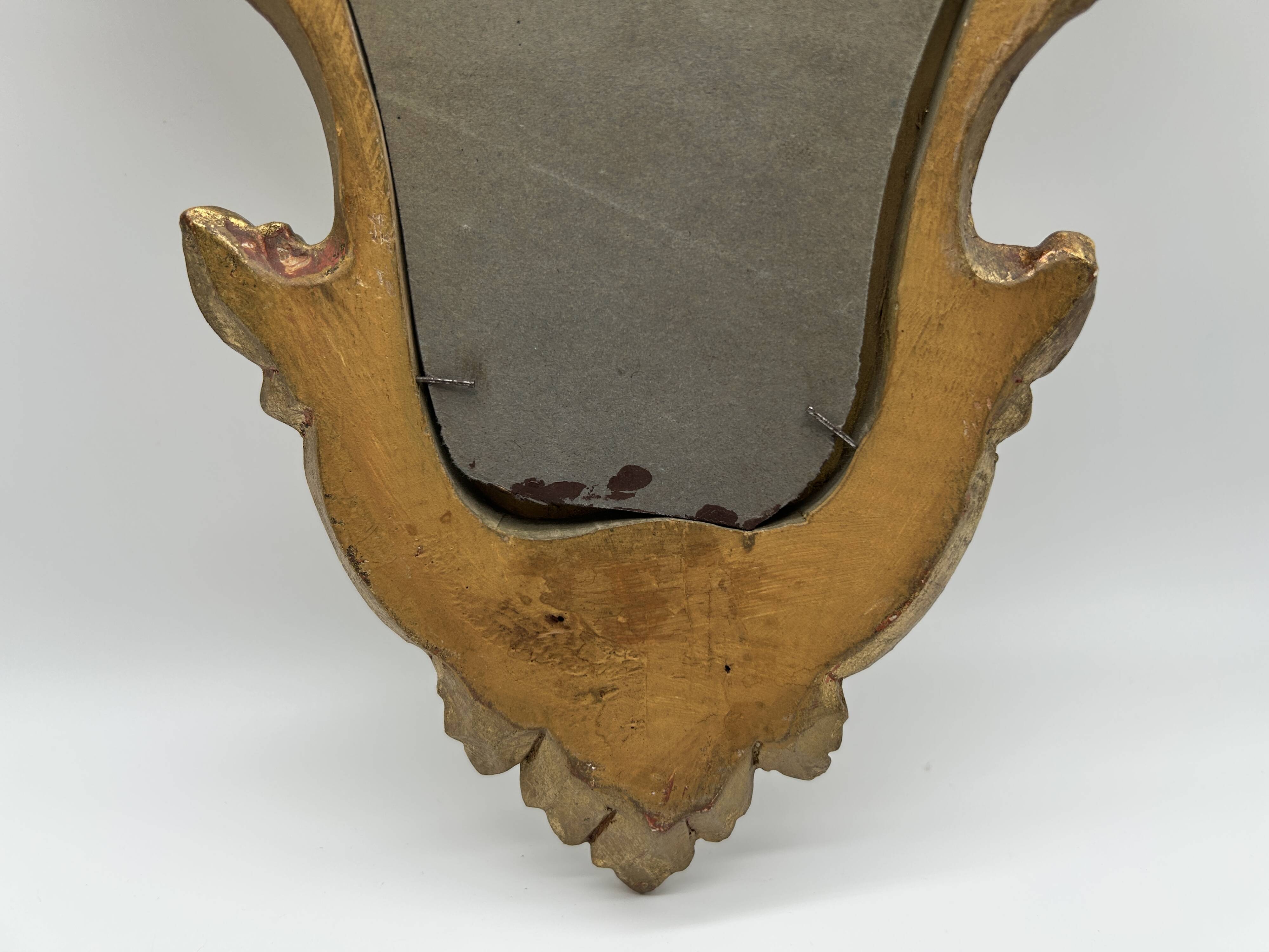 Wooden mirror with gilded stucco