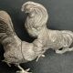 Showcase objects, two 20th century metal rooster and hen subjects