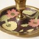 Set of 2 round golden metal candle holders and floral patterns