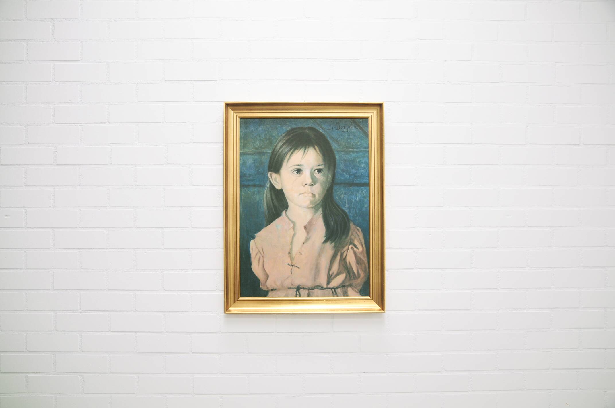 vintage gold frame with portrait of crying girl by Bragolin