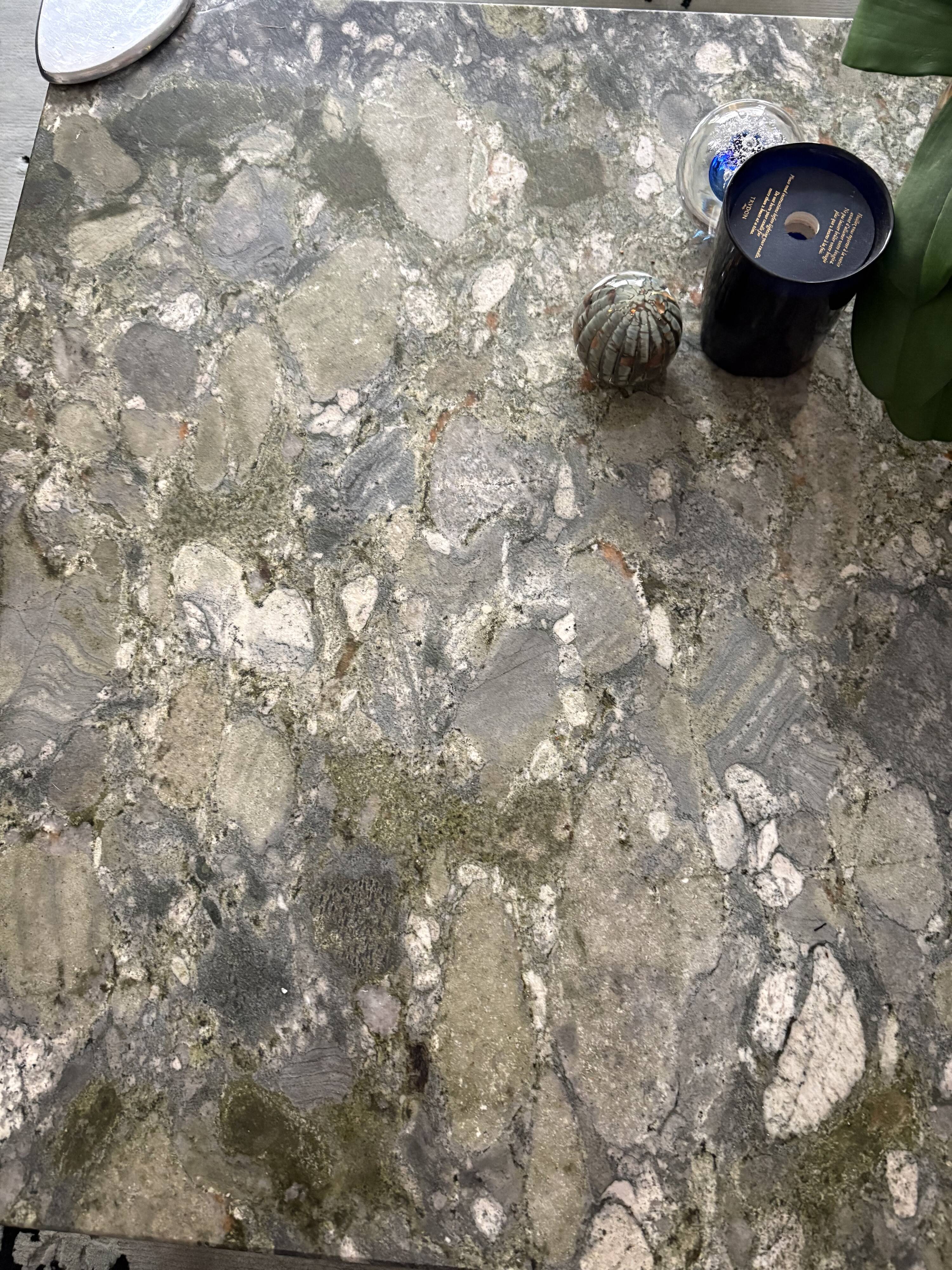 Contemporary coffee table with a marble top and steel base.