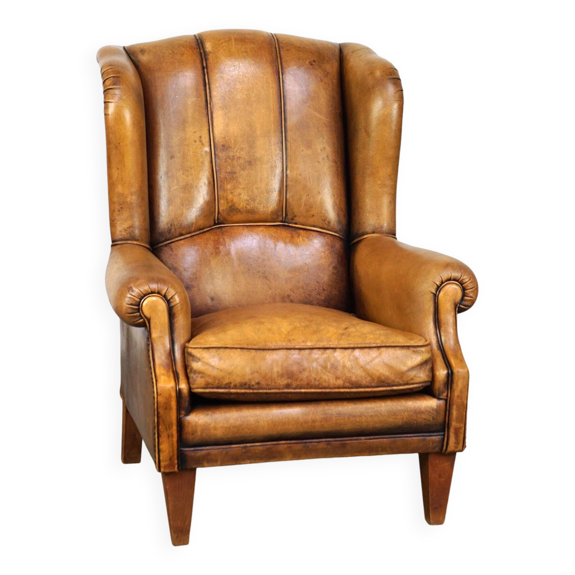 Sheepskin wingback chair with a unique design and a beautiful patina