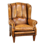 Sheepskin wingback chair with a unique design and a beautiful patina