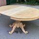 Extendable round dining table with central art deco leg, renovated in raw wood