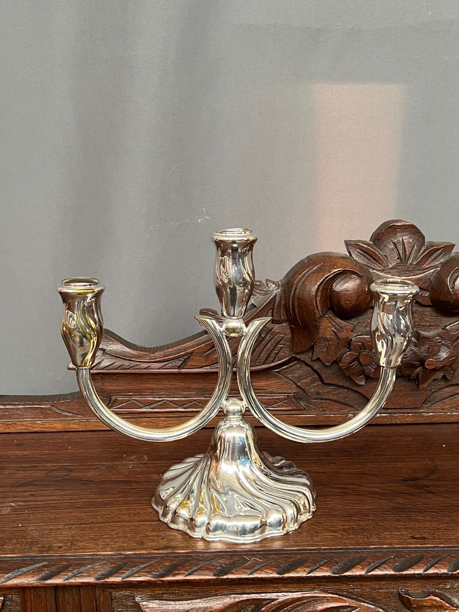 A pair of candlesticks. silver metal with gold decoration.