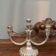A pair of candlesticks. silver metal with gold decoration.