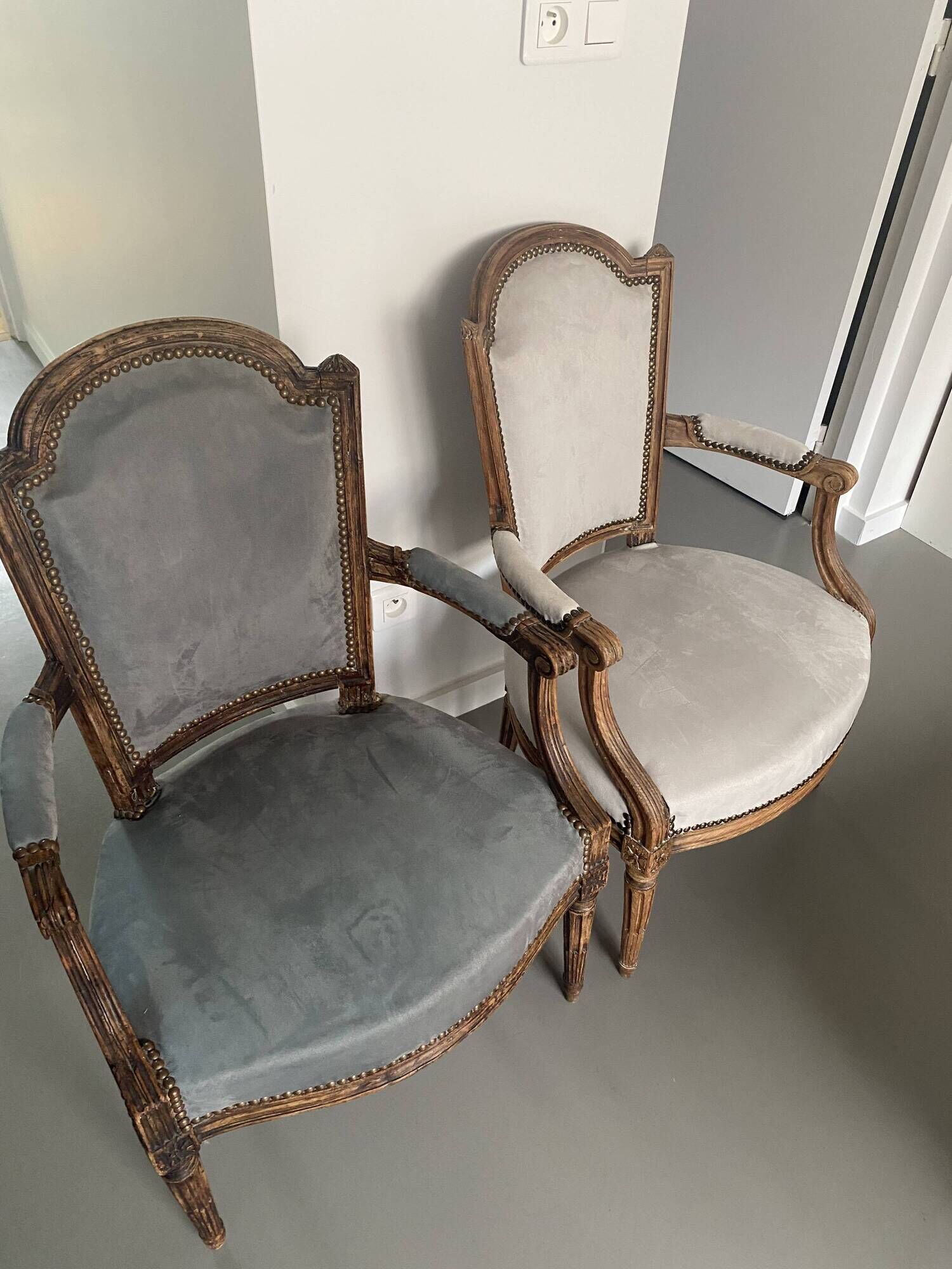 Pair of cabriolet armchairs in light grey and dark grey Louis XV style.