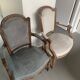 Pair of cabriolet armchairs in light grey and dark grey Louis XV style.