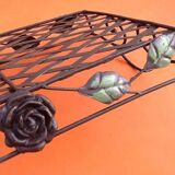 Rectangular metal serving tray with floral decoration.