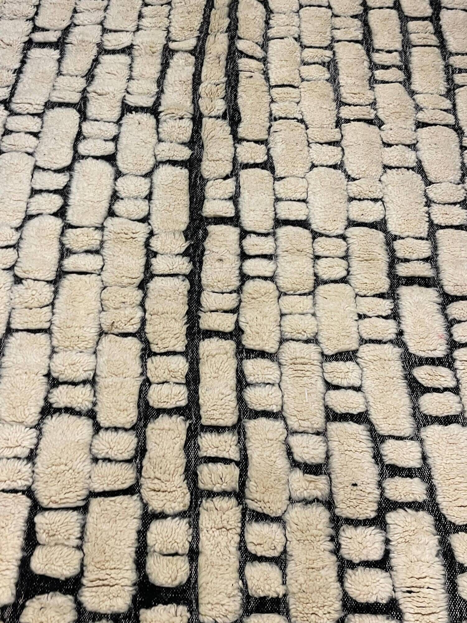Large cream and black checked Berber rug, 280 × 200 cm.