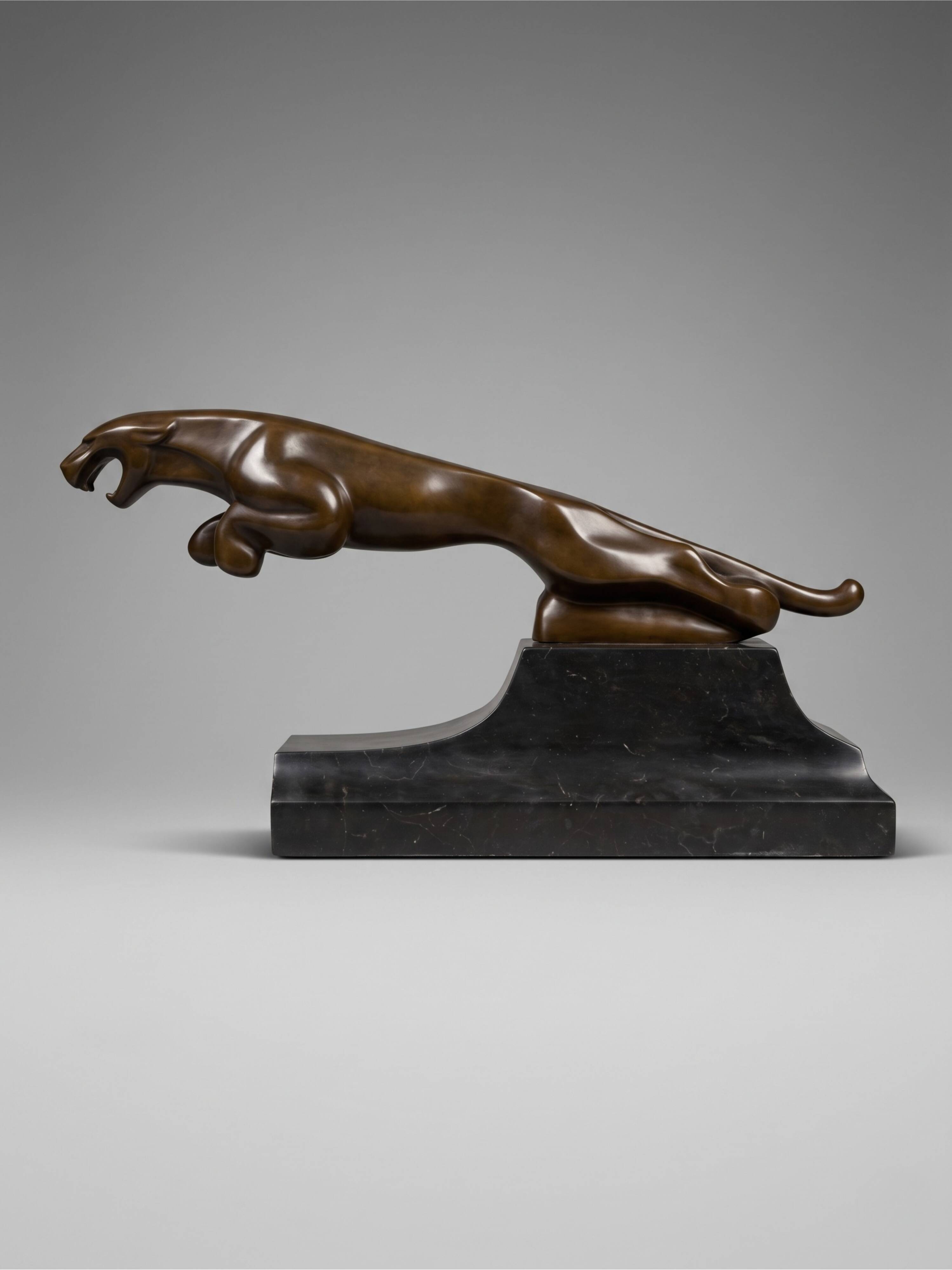 Large Art Deco bronze patinated Jaguar sculpture on an architectural base.