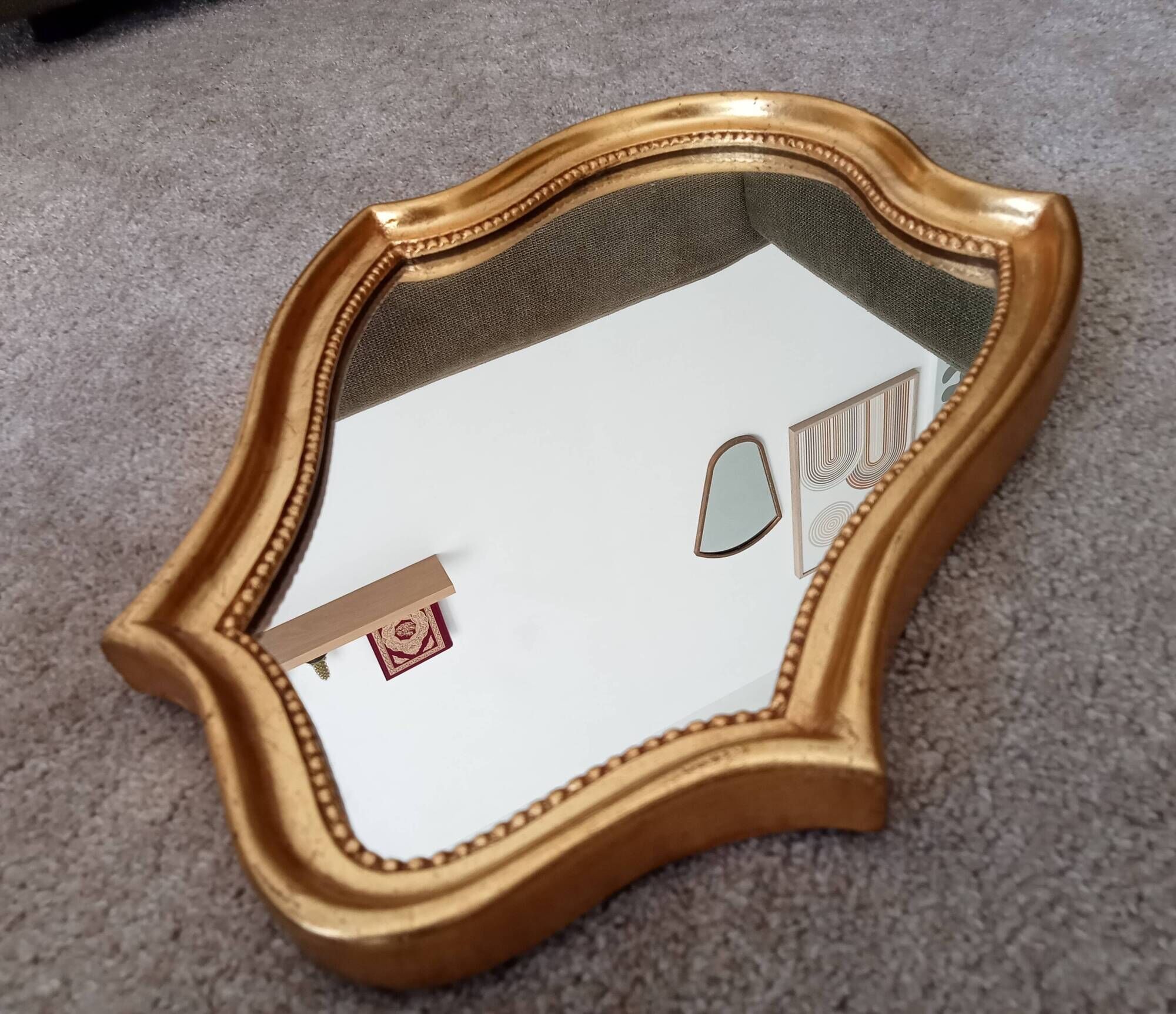 Vintage baroque mirror in gilded wood in the Louis XV style.