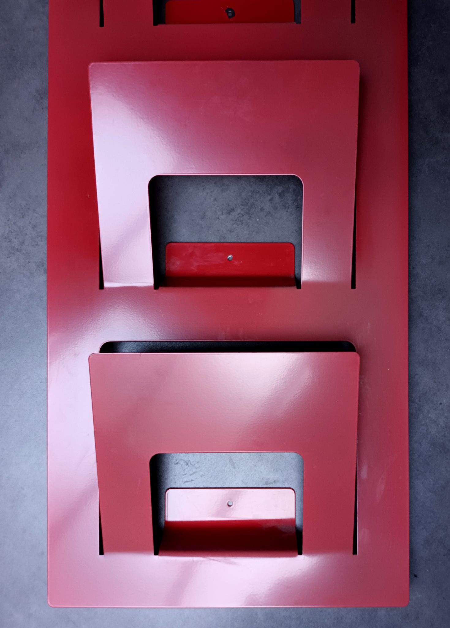 Vintage red metal wall magazine rack