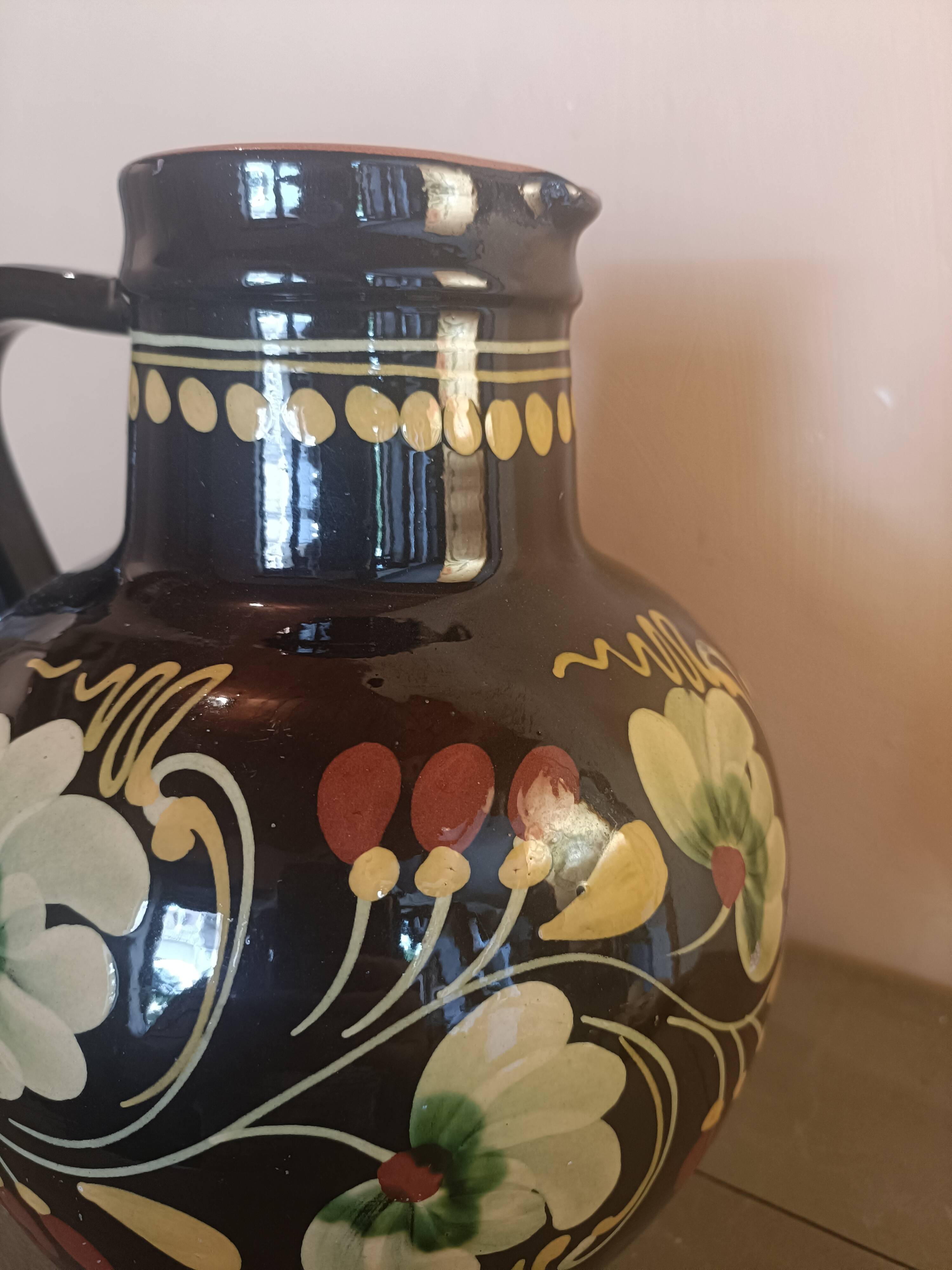 Large glazed terracotta pitcher with floral decoration