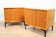 A pair of vintage mid-century bedside tables with oak sliding doors