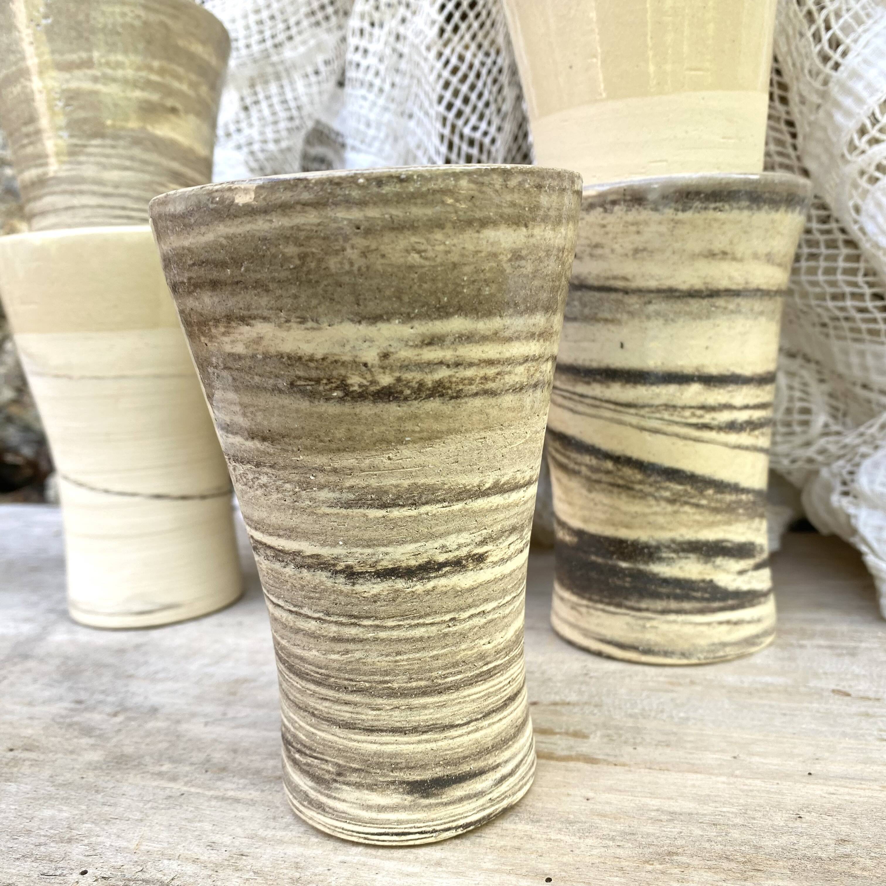 High ceramic cups made of mixed clay.