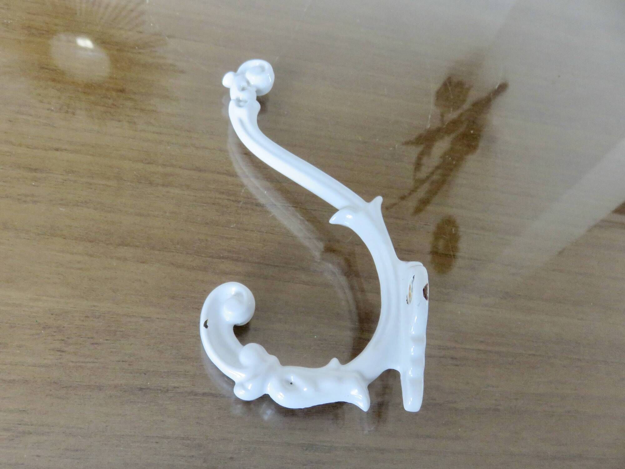 Pair of Art Deco white cast iron coat hooks from the 1930s and 1940s