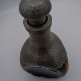 Vintage decanter in glass and tin.