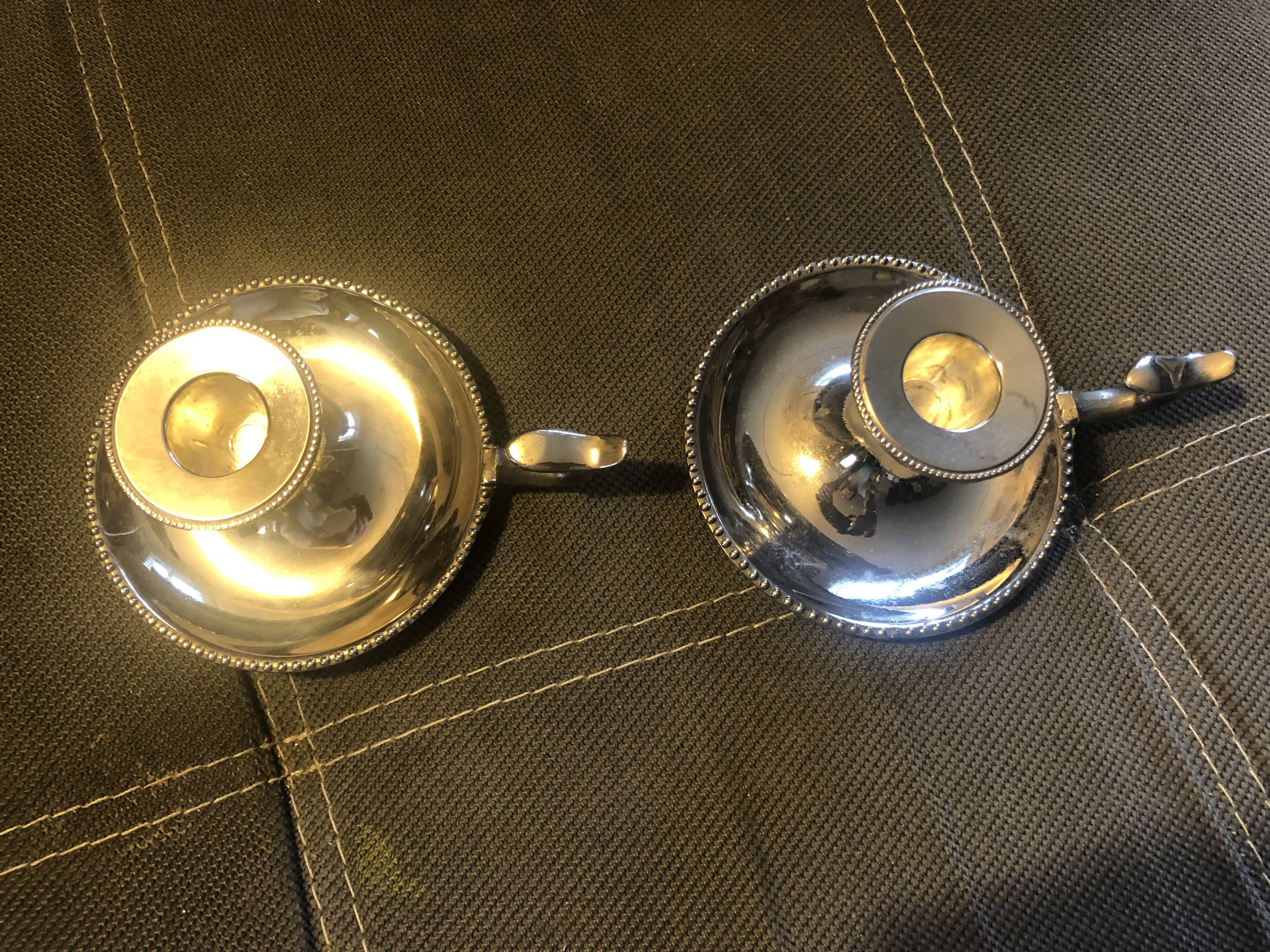 Pair of silver metal hand candle holders