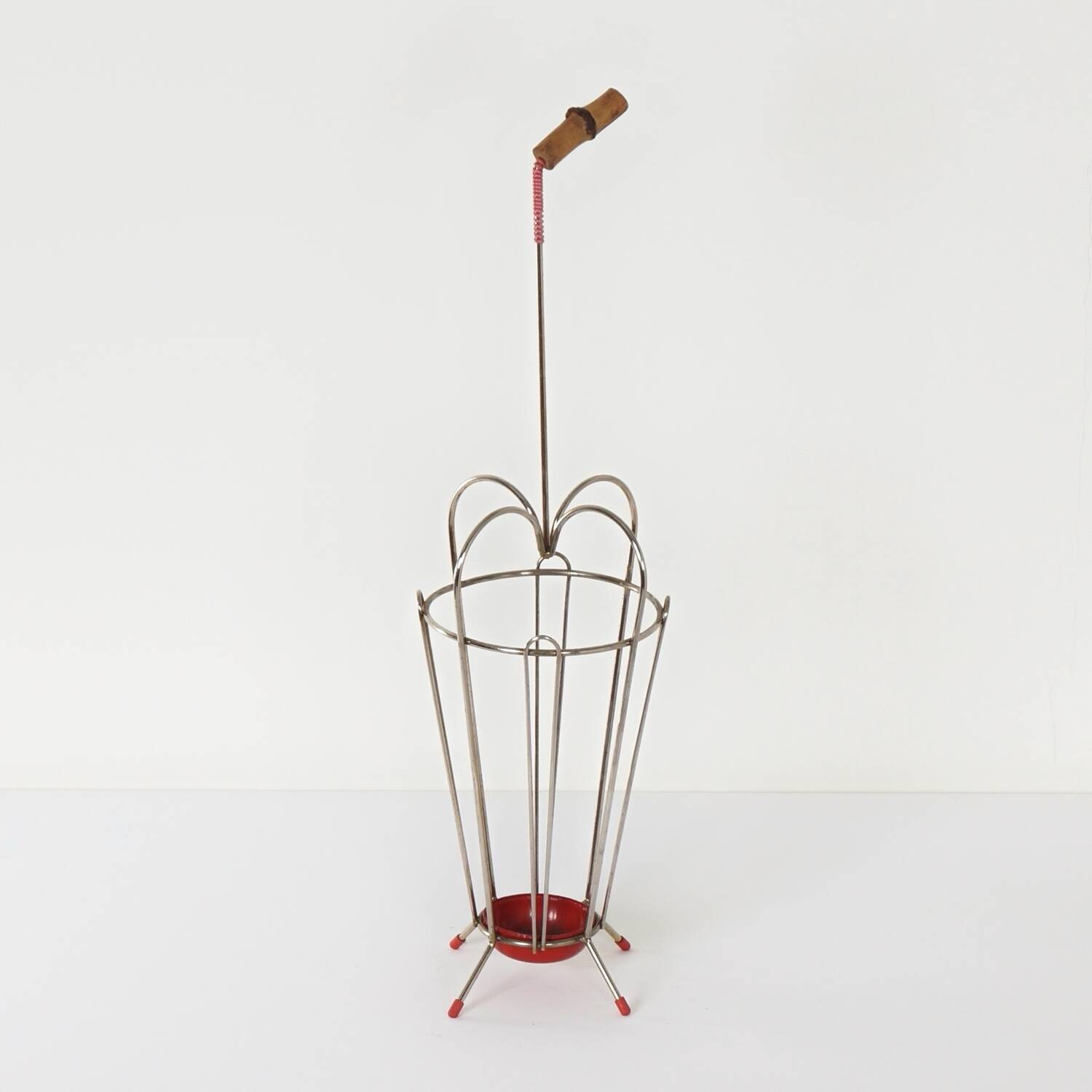 VINTAGE UMBRELLA STAND OF CURVED METAL, RED DETAILS AND A BAMBOO HANDLE, 1950S
