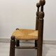 Low fireplace chair in the style of Charles Dudouyt – wood and straw seat.