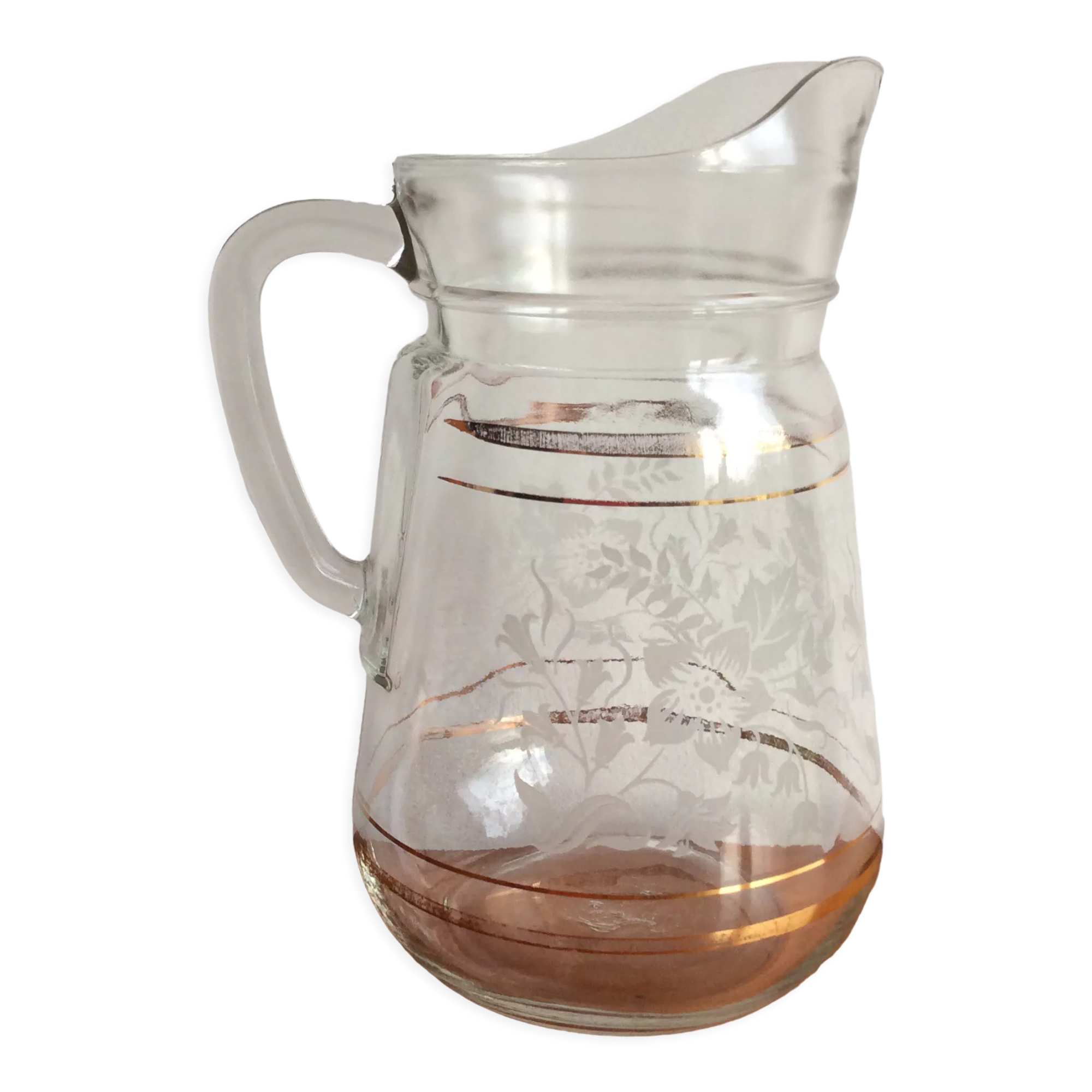 Old glass water pitcher with white flowers in relief with gold edging