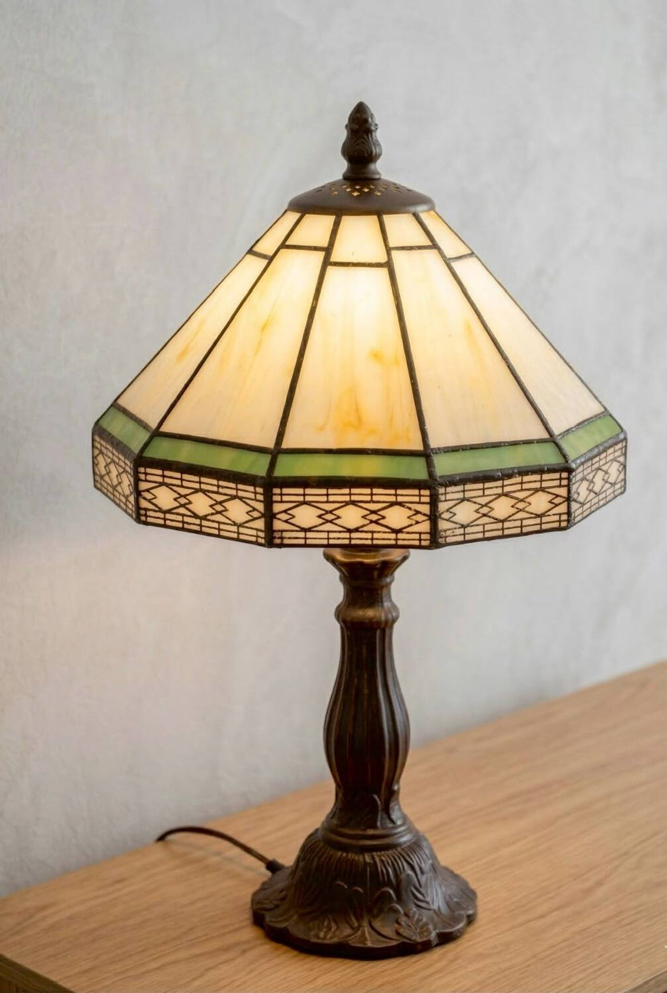 Tiffany-style stained glass lamp in green and amber white with vintage inspiration.