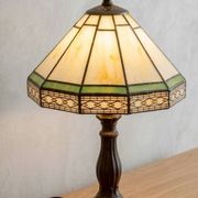 Tiffany-style stained glass lamp in green and amber white with vintage inspiration.