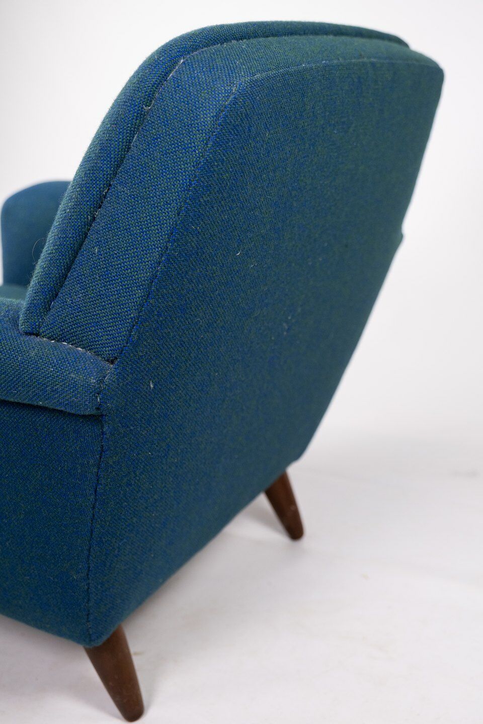 Armchair upholstered with dark blue wool fabric and legs in dark wood, of danish design, 1960s