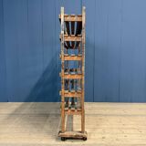 Old wooden workshop shelf with cast iron wheels.