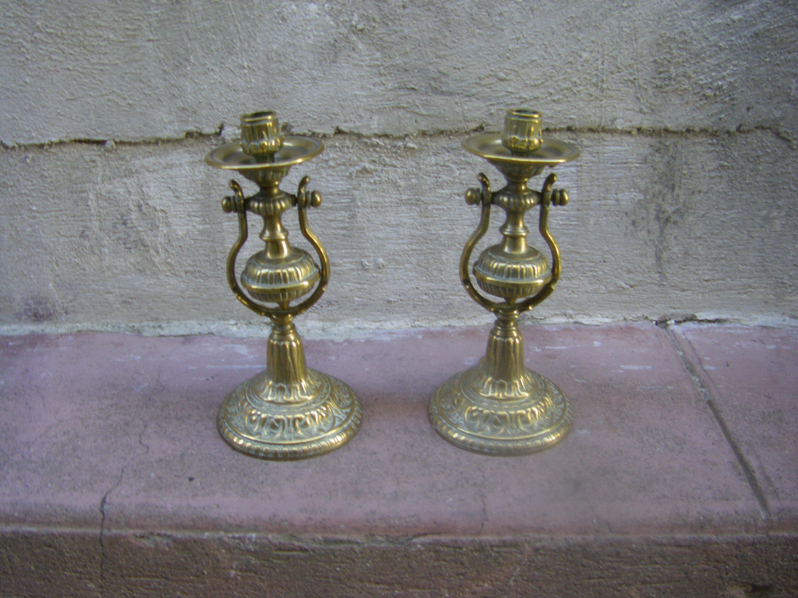 Pair of pendulum candle holders