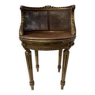 Louis XVI style armchair in wood and gilded stucco, 20th century.